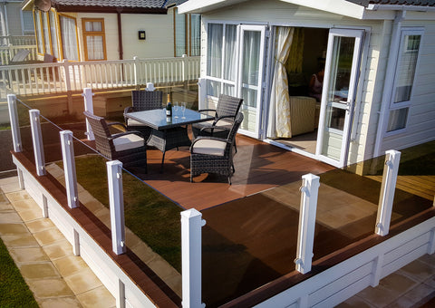 Tinted glass panel balustrades outside on balcony decking