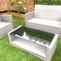 A grey toughened glass table top on an outdoor rattan table.