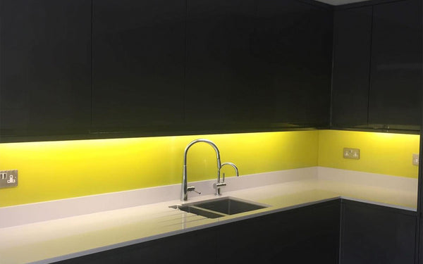 Yellow painted glass kitchen splashback with led backlighting