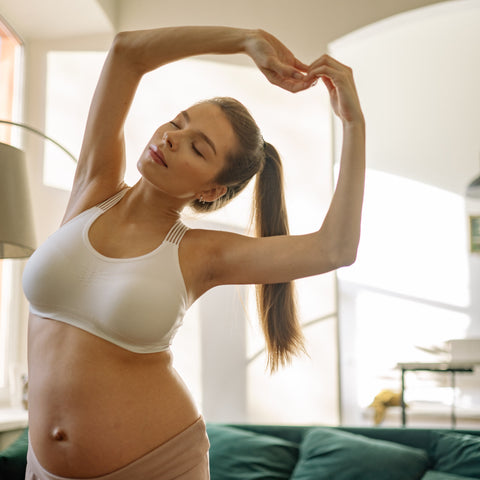pregnant woman stretching after a workout