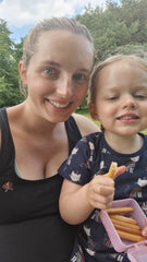 Photo of me and my daughter smiling. My daughter is holding a breadstick.