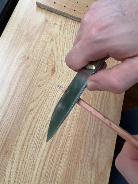 sharpening a pencil with a folding knife