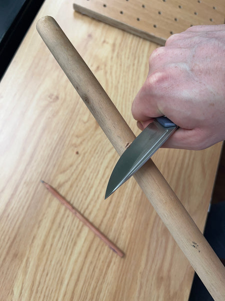 whittling wood using folding knife