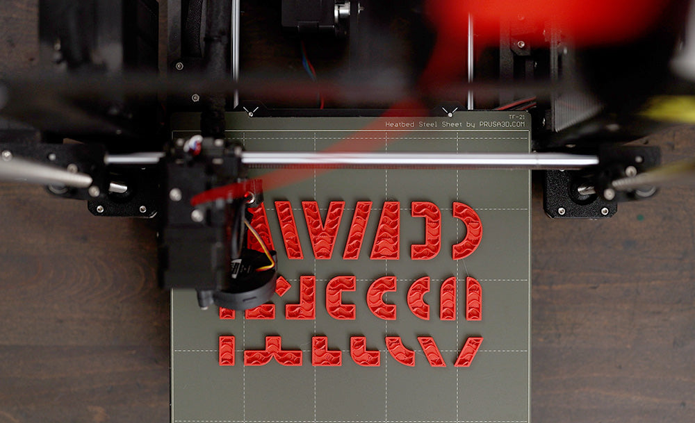 A top view of a 3D printing in the middle of printing the grips for one BlockFace Kit