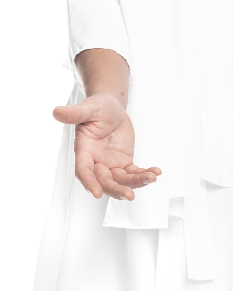 A person in a white robe extends their hand, offering comfort. Symbolic Christian bereavement gift.