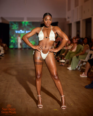 Black woman modeling ivory two piece fringe bikini in heels