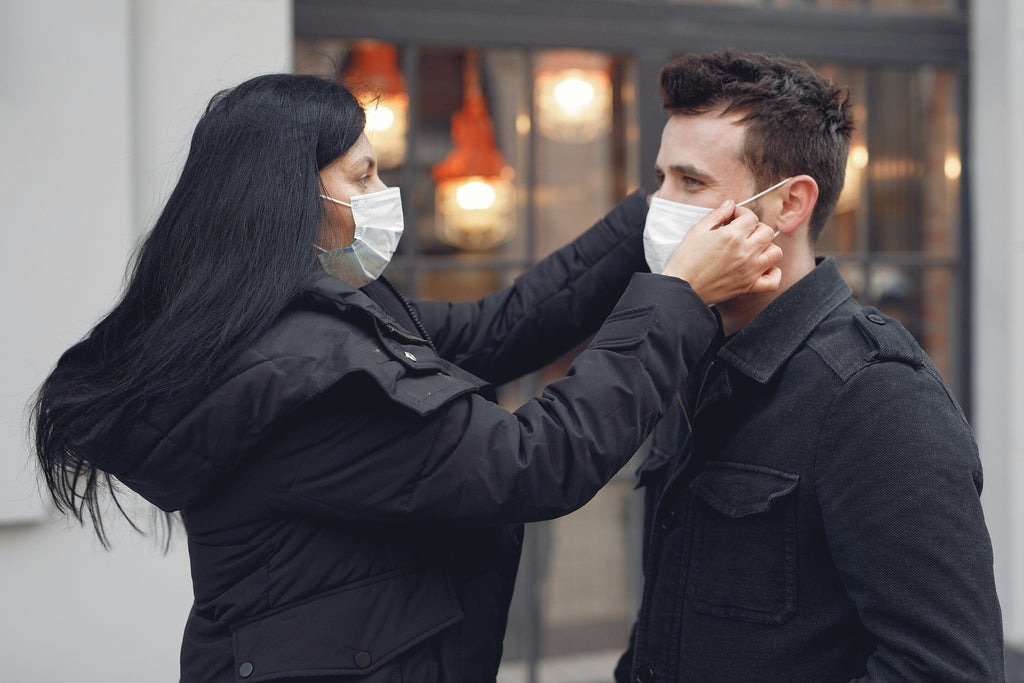 two people wearing black jacket and face mask
