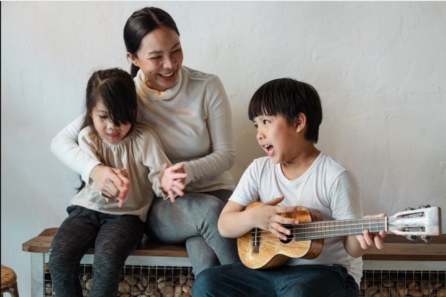 happy family singing song and a boy playing a guitar