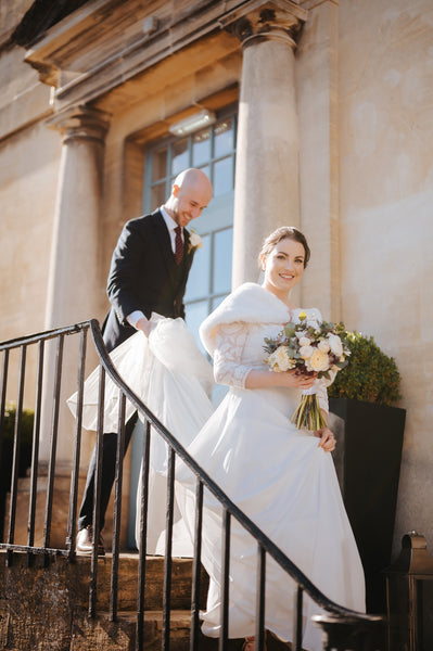 bride and groom walking down steps