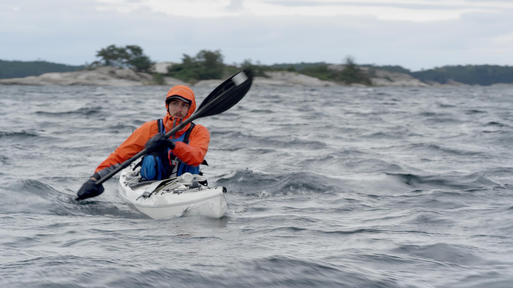 Person kayaking in waves