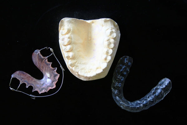 3 dental guards on a black table