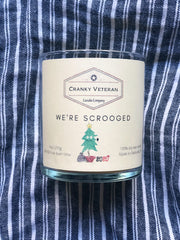 hand poured soy candle on blue tea towel by veteran entrepreneur 