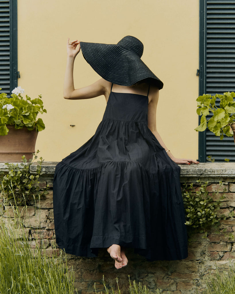 Jessica wears the Dorothy Dress in black with a huge oversized hat