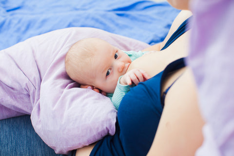 baby being fed in the Rugby Hold feeding position