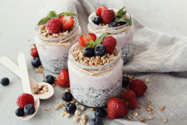 Chia seed pudding in glass with strawberry topping