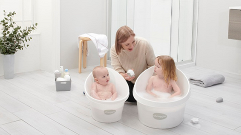 parent bathing baby and toddler