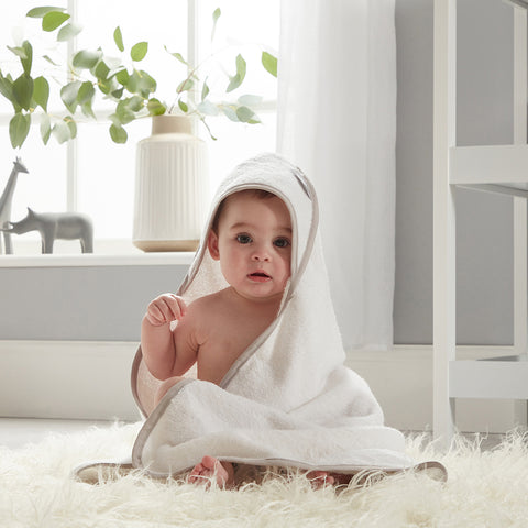 baby in wearable hooded white towel