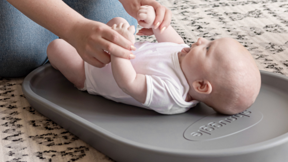 Grey Squishy Changing Mat with baby in vest