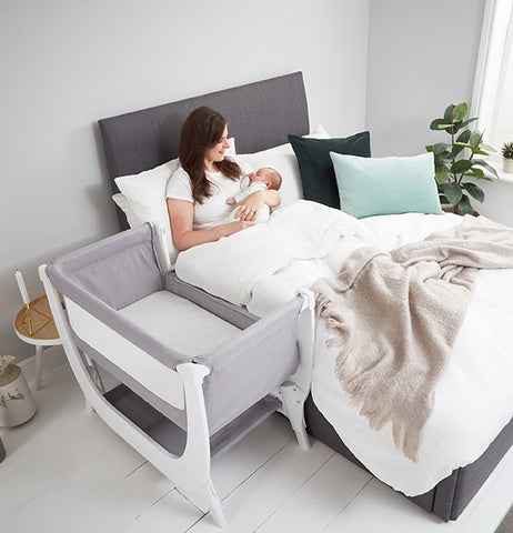 mum nursing baby in bed with air crib bedside bed