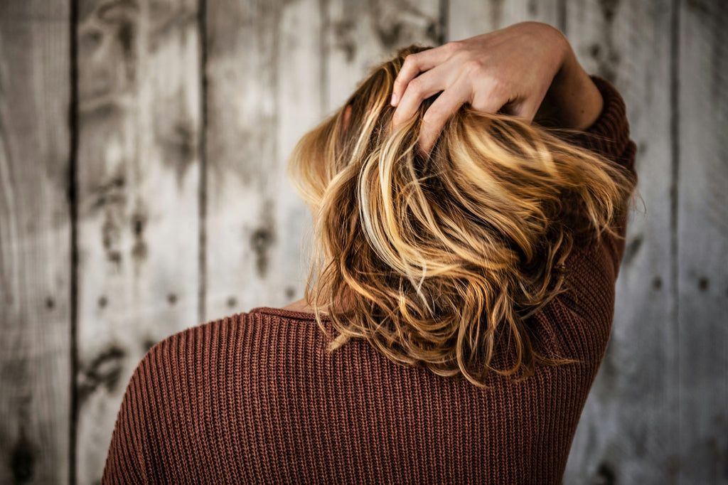 A woman showing thick hair from the back