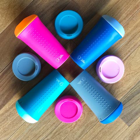Different reusable silicone cups mix and matched in colors sit on a table
