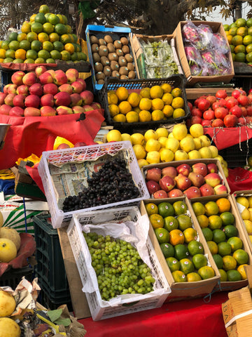 Farmers market stand with assorted fruits and veggies 