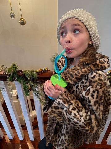 Kid sipping from a reusable Gosili cup using silistraws, a reusable, connectable silicone straw