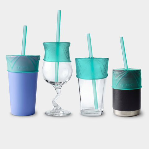 Four different cups in varying sizes and materials stand next to each other. Each one has a silicone lid and straw on it. 