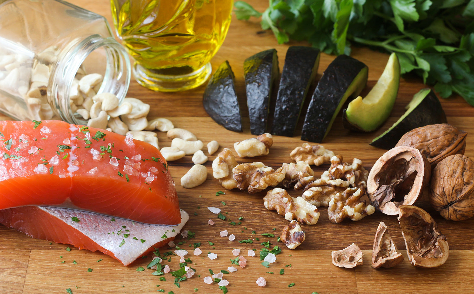 Salmon, walnuts, avocado and other brain healthy foods on cutting board