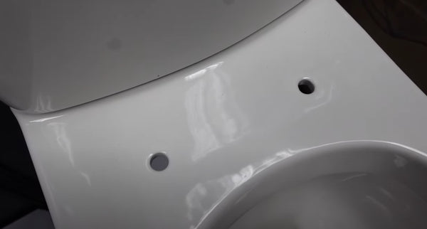 measure-the-holes-on-the-toilet-for-changing-the-toilet-seat-cover