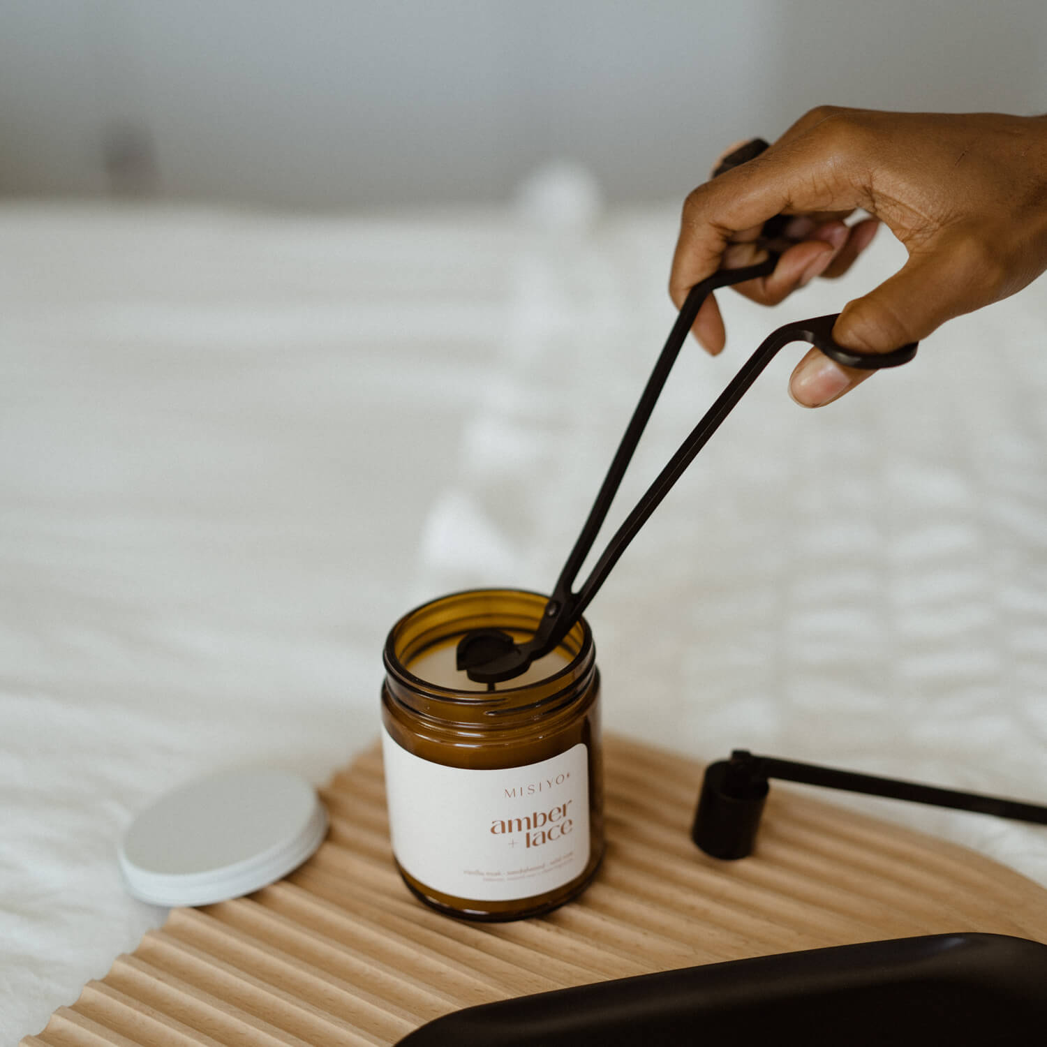 trimming the wick of a misiyo candle jar with black wick trimmers