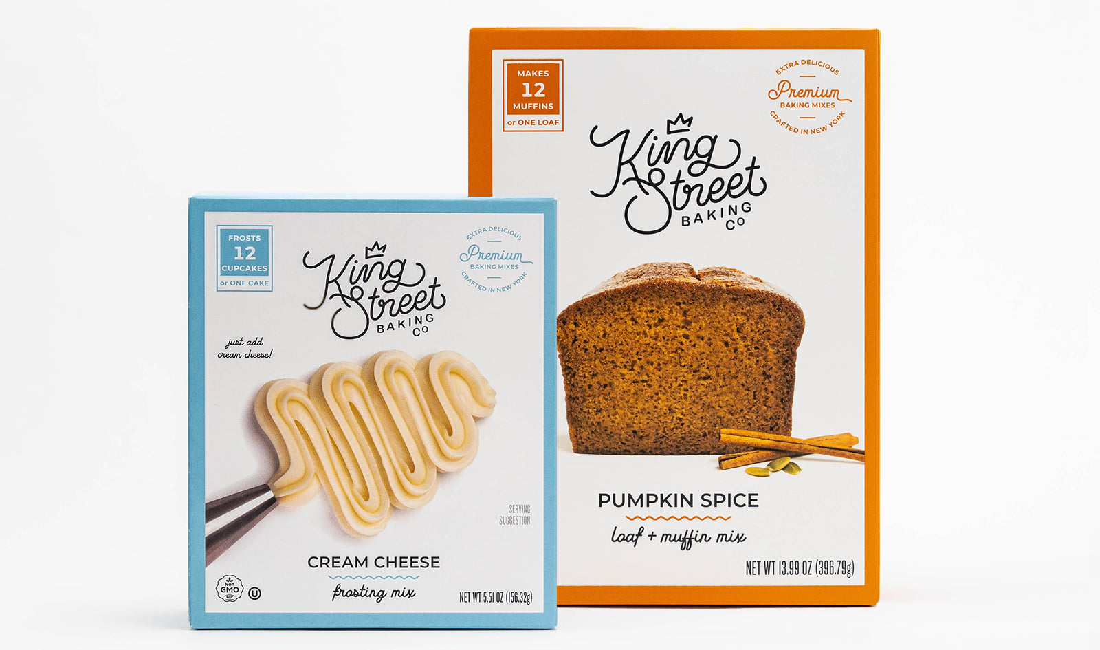 A light blue box of King Street Baking Co.'s Cream Cheese Frosting Mix (left) next to a box of King Street Baking Co.'s Pumpkin Loaf and Muffin Mix.