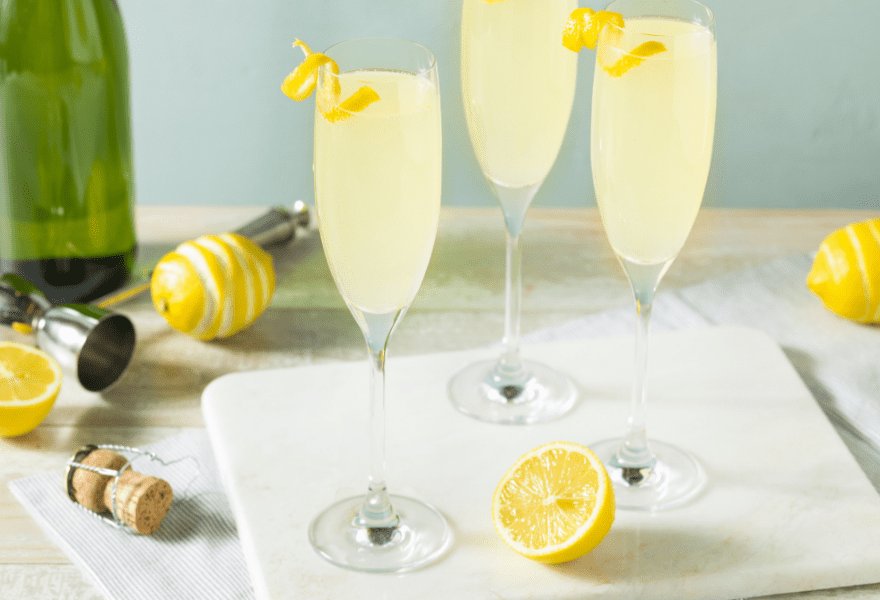 Two champagne glasses with non-alcoholic French 75 made with Sans Bar Notting Hill Stroll