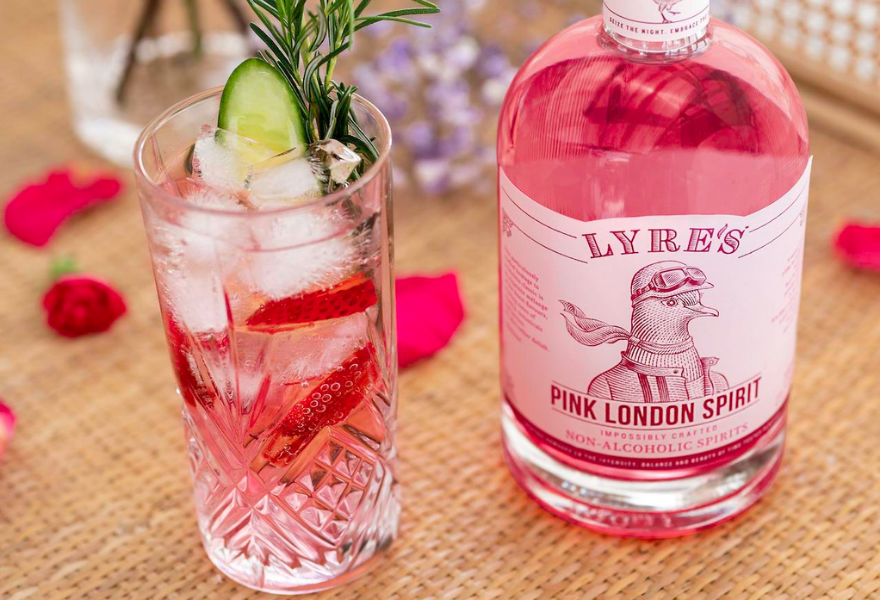 A bottle of Lyre's Pink London Spirit next to a non-alcoholic gin mocktail
