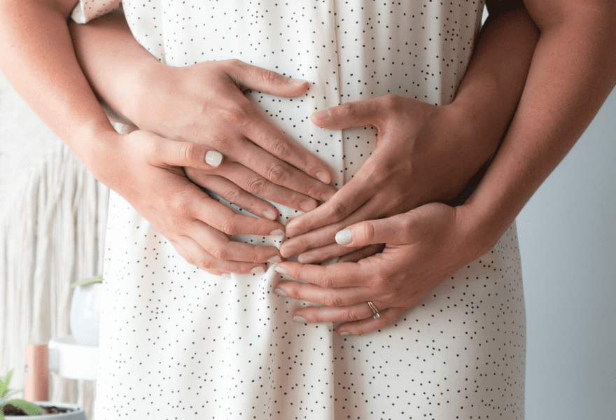 Pregnant woman holding her belly