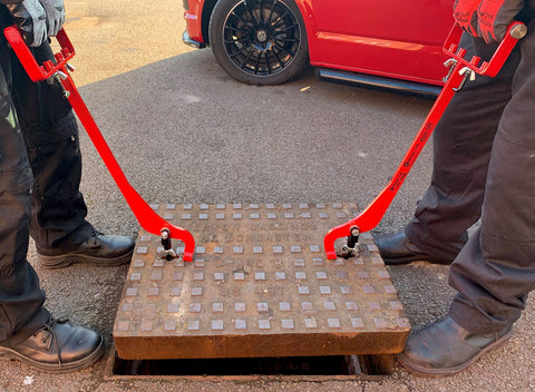 Manhole cover lifters