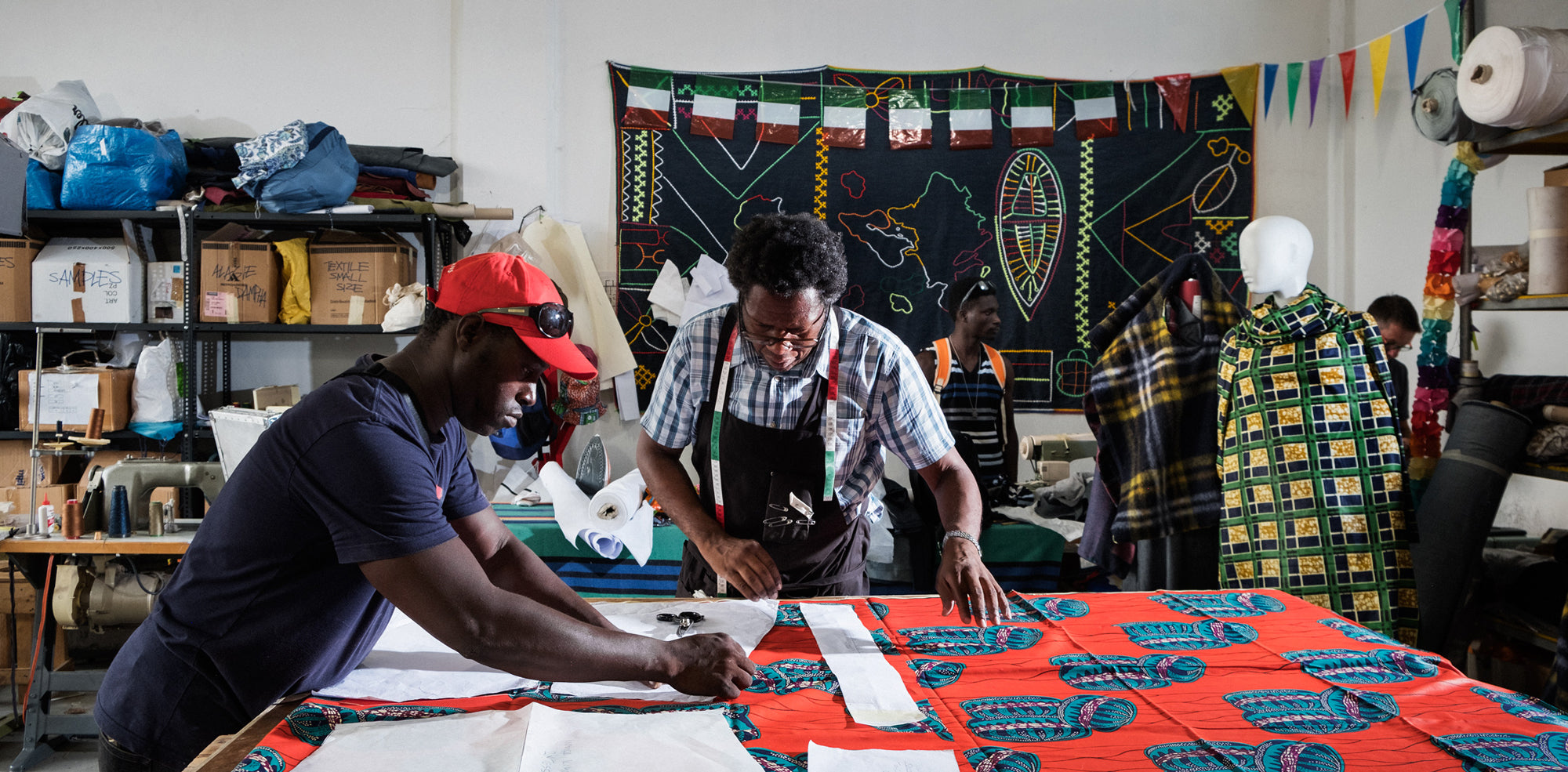 Two tailors working in the atelier