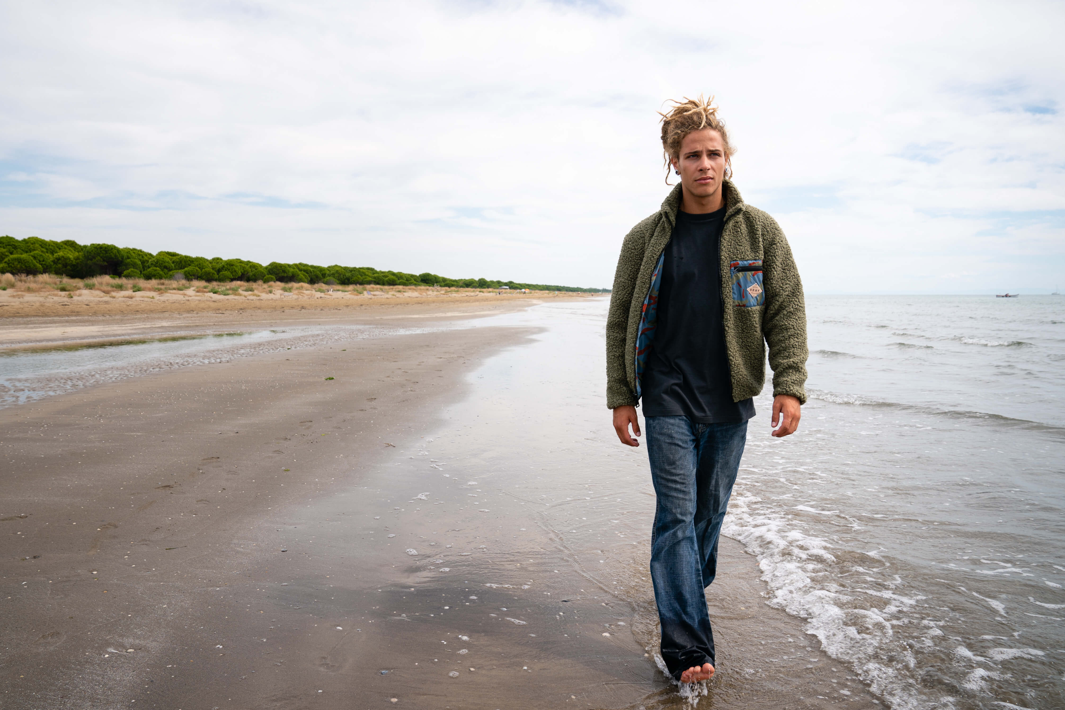 Boy walking on the beach wearing a SEAY outfit