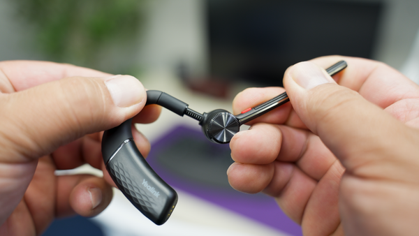 Yealink BH71 earpiece in hands showing how it adjusts for different sizes of ears