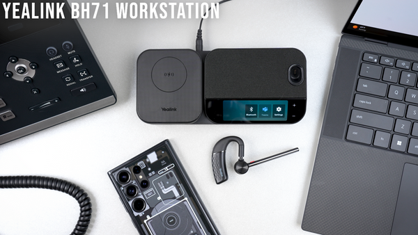 Yealink BH71 workstation Bluetooth wireless headset base, earpiece, case, and adapter on desktop next to computer and mobile phone 