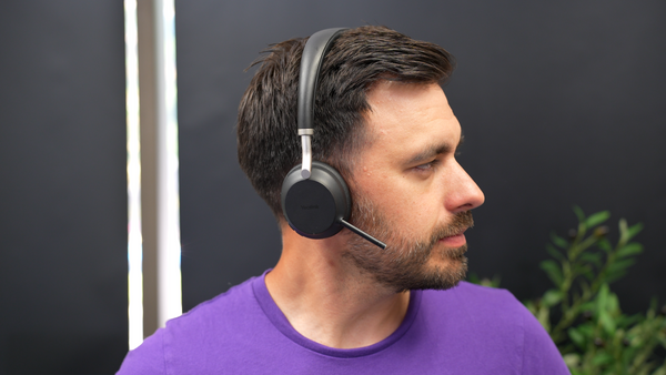 Side shot of a man wearing the Yealink BH72 headset