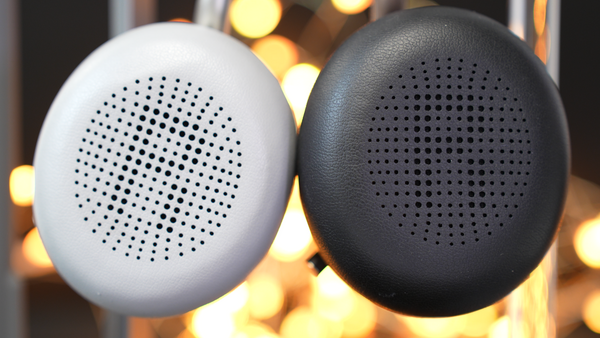 Close up image of two Yealink BH72 ear cushions. One black, one light gray with both showing perforations for better sound flow, and right, left side designations