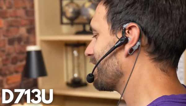 man wearing a Discover D713 wired headset at desk