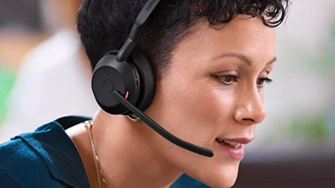 close up view of a woman wearing a headset while being on a call