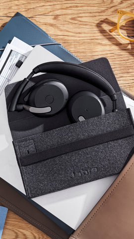 Jabra Evolve2 65 Flex headset folded down and half way in the travel case on desk