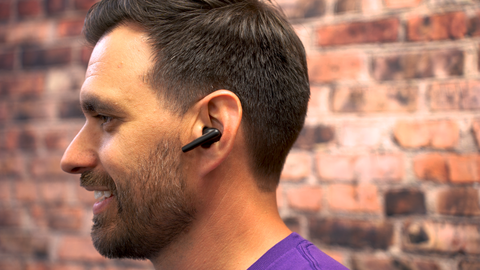 Side profile of man wearing Poly Voyager Free 60 earbud