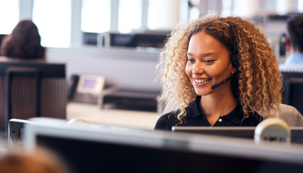 woman smiling while on phone call in office