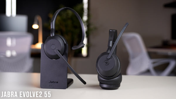 Jabra Evolve2 55 mono in charging stand, and duo on desktop