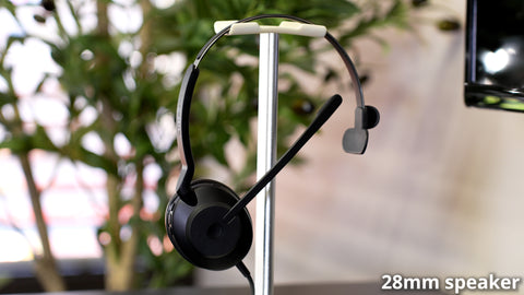 Jabra Evolve2 30 wired USB headset hanging on a headset hanger on an office desk top