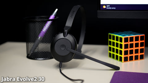 Image of a Jabra Evolve2 30 wired USB headset sitting upright on a desk top